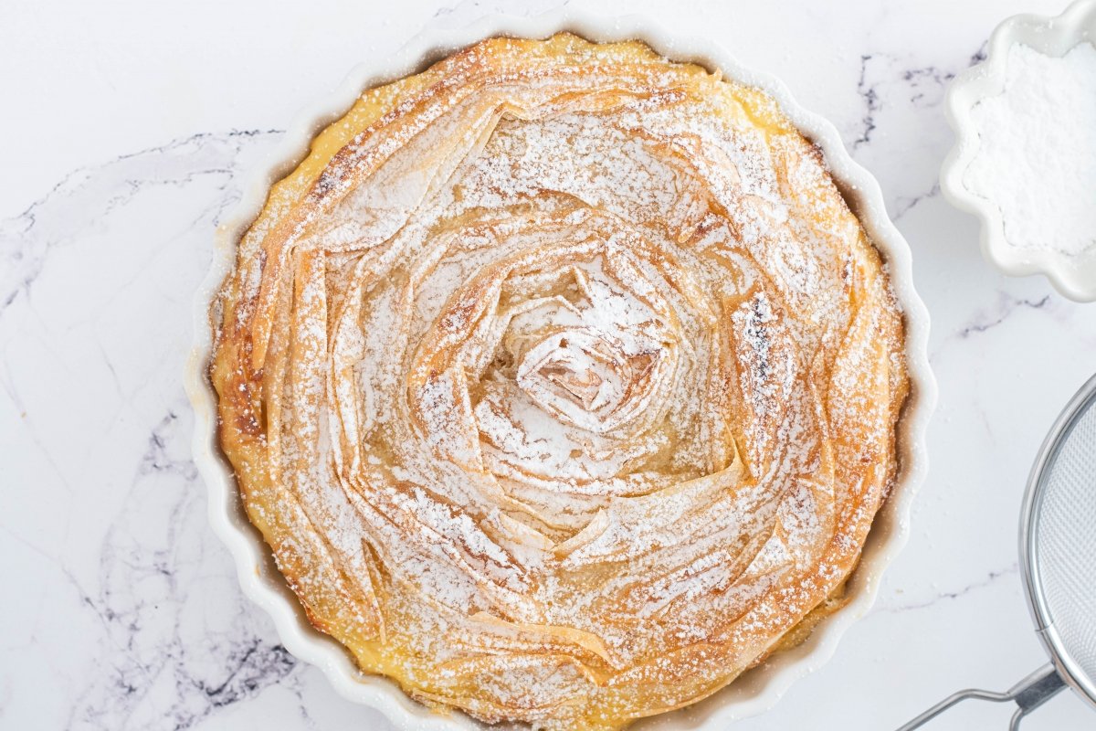 Espolvoreamos con azúcar glas la tarta flor