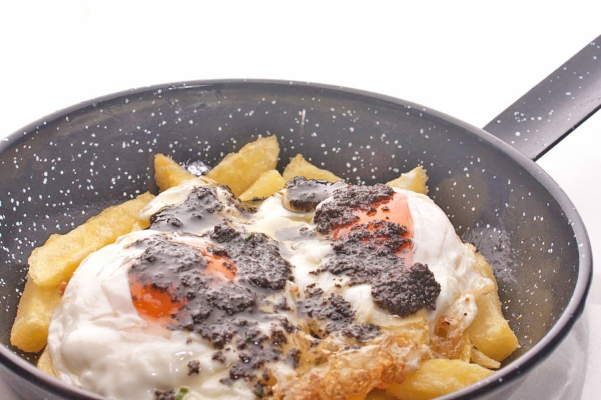Huevos rotos con patatas y trufa de Taberna Arzábal